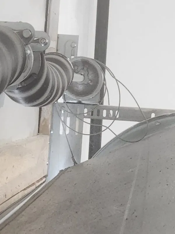 Real garage door lift cable displaced from its drum
