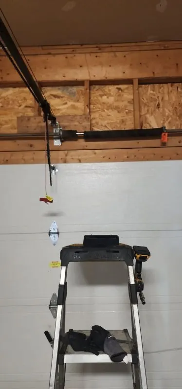 Garage door torsion spring replacement above a sectional door